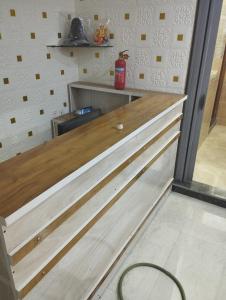 a kitchen with wooden counter tops in a room at RDA Dormitory in Raipur