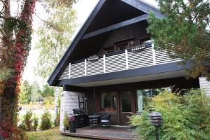 a house with a deck and a balcony at Villa Jupperi Espoossa in Espoo