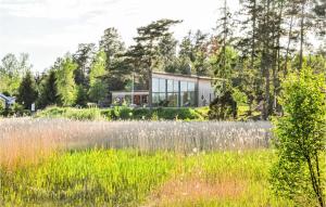 a house in the middle of a field at 5 Bedroom Beautiful Home In Karlstad in Karlstad