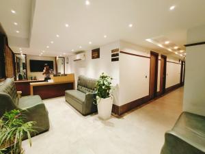 a lobby with couches and a waiting room at Aura Rooms in Dehradun