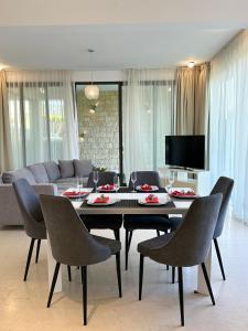 a living room with a table and chairs and a couch at Akamas Turtle Beach №2 in Neo Chorio