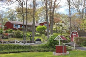 a house with a red barn and a yard at Heidi's Inn in Brewster