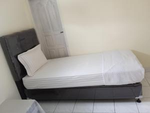 a small bed in a room with a white mattress at Balqis Homestay Syariah II Pasar Aur Kuning in Bukittinggi