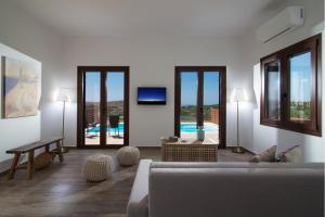 A television and/or entertainment centre at Stylish Villa Liatiko - Heated pool - Amazing views