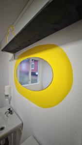 a yellow light hanging over a sink in a bathroom at Orrefors Vandrarhem in Nybro