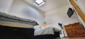 a bedroom with a bed and a window and a spotlight at Deepcut Lodge Bed & Breakfast Self Service in Camberley