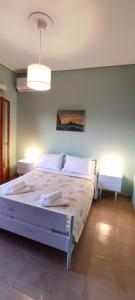 a bedroom with a large bed with two night stands at Anchialos seafront appartement in Nea Anchialos