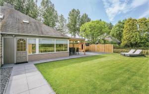 a backyard with a lawn and a house at Oud Kempen Bungalow 37 in Stavenisse