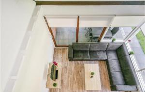 an overhead view of a living room with a couch and table at Oud Kempen Bungalow 37 in Stavenisse +11 photos