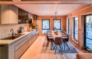 a kitchen with a long table and chairs in it at Amazing Home In Lillehammer With 5 Bedrooms, Sauna And Wifi in Lillehammer