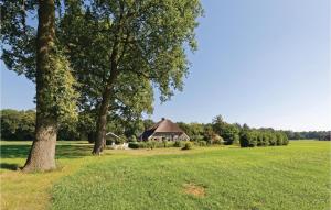 a house in the middle of a field with trees at Dampol in Ommen