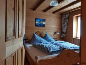 a bedroom with a bed with blue pillows on it at Zirbennest in Serfaus