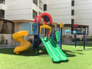 a playground with a slide in a yard at Porto said بورتوسعيد شاليه ارضى in Port Said