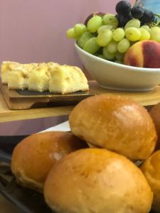 a table with a plate of bread and a bowl of fruit at Hotel Ristorante Al Fiore in Peschiera del Garda