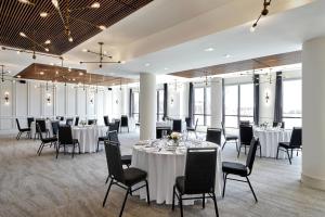 a banquet room with tables and chairs and windows at Courtyard by Marriott Calgary South in Calgary