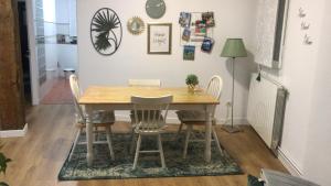 a dining room with a wooden table and chairs at El Botxito in Bilbao