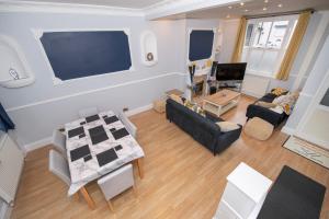 an overhead view of a living room with a table and chairs at EmmaDale Bridington Town Centre Sleeps 10 in Bridlington