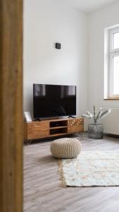 a living room with a large flat screen tv at Casa Mare in Meiningen