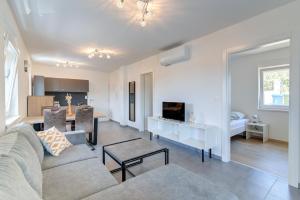 a living room with a couch and a dining room at Damar Apartmani in Senj +2 photos