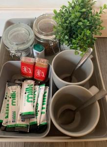 a tray with toothpaste and a bowl and a plant at BYRON SQUARE COTTAGE in Hucknall