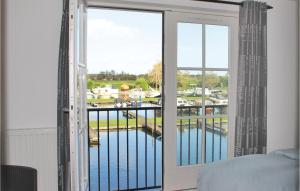 a bedroom with a window with a view of a marina at Beautiful Home In Breukelen With Wifi in Breukelen