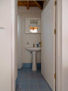 a bathroom with a sink and a mirror at Summer Garden Studio - village location in Koroni
