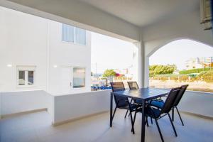 a dining room with a table and chairs and a window at Asteria Apartments in Analipsi