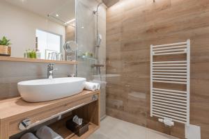a bathroom with a sink and a shower at Vitalhotel Kaiserhof in Seefeld in Tirol