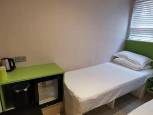 Voodi või voodid majutusasutuse 珀依旅馆 Pop E INN toas