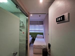 Voodi või voodid majutusasutuse 珀依旅馆 Pop E INN toas
