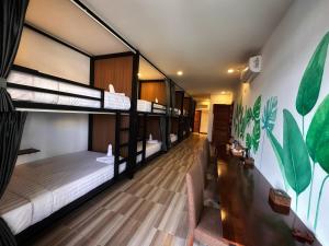 a dorm room with bunk beds in it at Monsoon Riverside Hotel in Phnom Penh