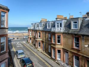 a view of a street with buildings and the ocean at Blue Seas in North Berwick