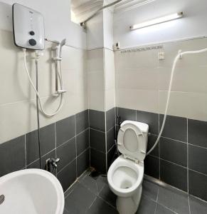 a bathroom with a toilet and a sink at MINA HOUSE Airport Apartment in Ho Chi Minh City