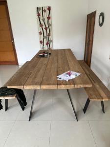 a wooden table in a room with at Villa Rob in Kerobokan