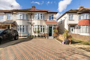 a house with a brick driveway in front of it at Lovely house (Ealing, London) in London