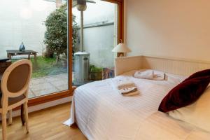 1 dormitorio con cama, escritorio y ventana en Splendid Modern House near Roland Garros, en Boulogne-Billancourt