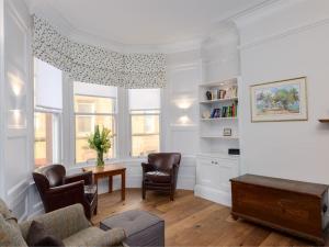 a living room with a couch and chairs and a table at By The Sea in North Berwick