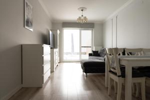 a living room with a table and a dining room at Apartament Symfonia Mozarta in Warka