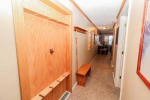 a hallway with a wooden door and a bench at ML328A 1BR Quiet corner unit! Close to Ballhooter in Snowshoe