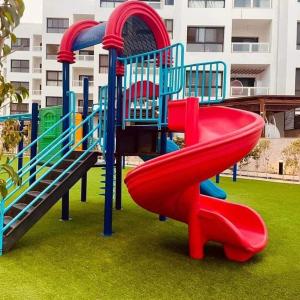 a playground with a slide in a park at Porto said بورتوسعيد شاليه غرفه وصاله in Port Said