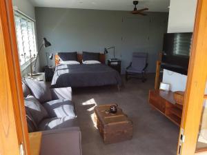 a living room with a bed and a couch at Riverstay on Clarence in Seelands