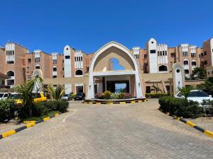 a large building with a courtyard in front of it at Cozy 2-bedroom beachfront villa-Lamera in Mombasa