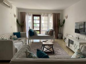 a living room with two couches and a table at Cozy 2-bedroom beachfront villa-Lamera in Mombasa