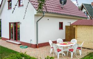 a patio with a table and chairs in front of a house at Nice Home In Wohlenberg With Kitchen in Wohlenberg