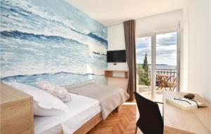 a bedroom with a large painting of the ocean at Stunning Home In Okrug Gornji With Heated Swimming Pool in Trogir