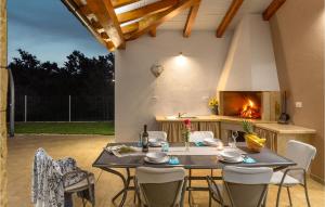 a patio with a table and chairs and a fireplace at 3 Bedroom Stunning Home In Zminj in Žminj