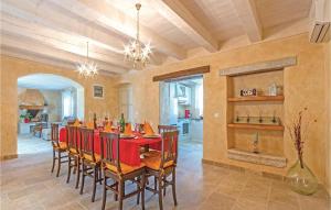 a dining room with a red table and chairs at Holiday Home Vodnjan With Fireplace I in Vodnjan