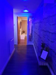 a hallway with a blue light in a room at Luxury 9ine Beautiful Bull Ring Apartment Free Parking in Birmingham