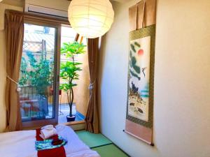 a room with a stuffed animal on a bed and a window at Japanese style villa - Vacation STAY 10392 in Tokyo