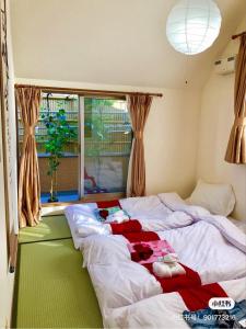 a bedroom with a bed with clothes on it at Japanese style villa - Vacation STAY 10392 in Tokyo